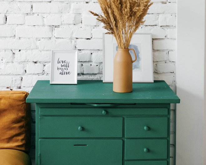 image of a green drawer with flowers on top.